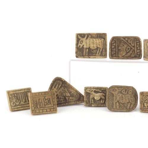 532 - Fifteen Islamic stone seals mostly carved with animals, the largest 10cm wide