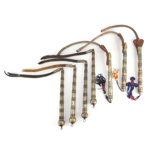 583 - Seven Afghan white metal and coppered Buzkashi whips