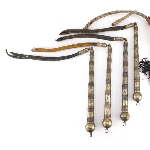 583 - Seven Afghan white metal and coppered Buzkashi whips