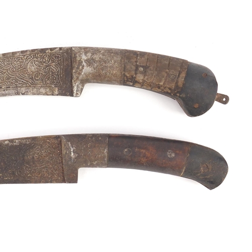 595 - Two Islamic Afghan Pesh Kabz daggers with sheaths, bone handles and engraved steel blades, the large... 