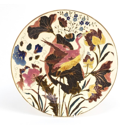 717 - Continental porcelain charger probably by Zsolnay Pecs, hand painted with a crane amongst flowers, i... 