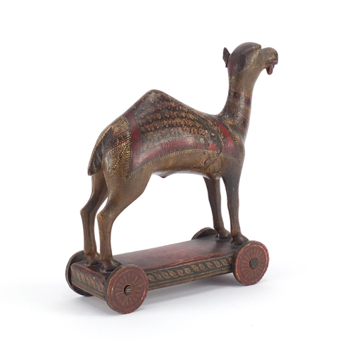 520 - Indian lacquered push along camel, hand painted with flowers, 30cm high