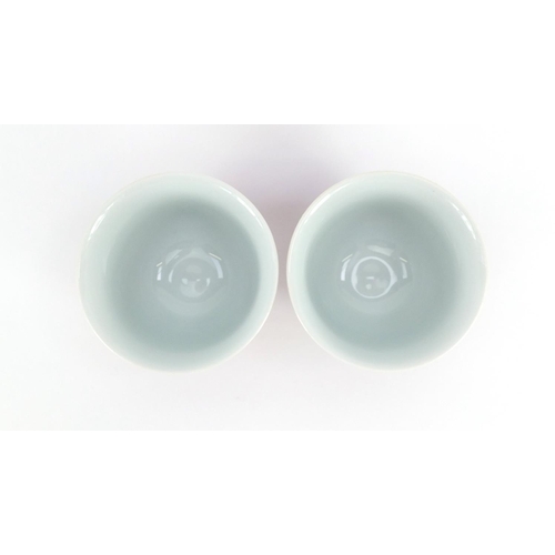 439 - Pair of Chinese porcelain Sang De Boeuf tea cups, character marks to the bases, each 6.5cm high