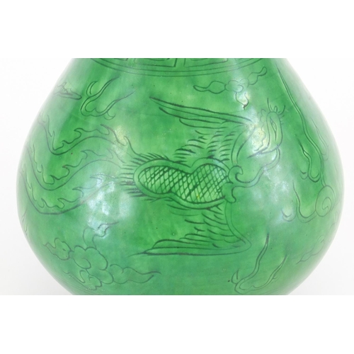 415 - Chinese porcelain green glazed disc top vase, incised under glaze with a dragon and phoenix chasing ... 