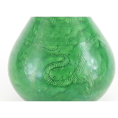 415 - Chinese porcelain green glazed disc top vase, incised under glaze with a dragon and phoenix chasing ... 