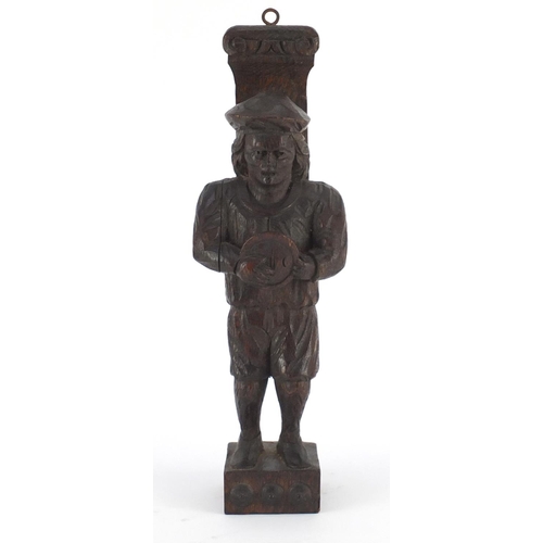 40 - Antique Continental wood carving of a peasant wearing a hat and carrying a bowl, 31.5cm high