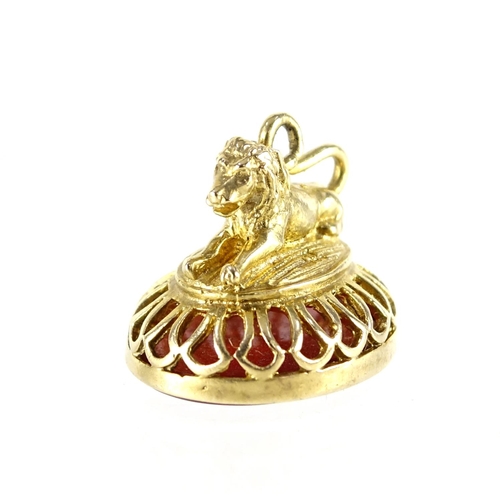 867 - 9ct gold lion design carnelian seal and a 9ct hardstone spinner fob, 14.4g