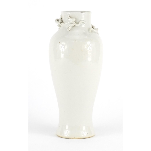 414 - Chinese Blanc de Chine porcelain baluster vase, decorated in relief with two dragons, 24cm high