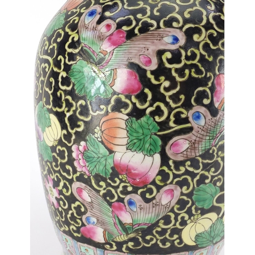 372 - Chinese porcelain vase with twin handles, hand painted in the famille noir palette with butterflies ... 