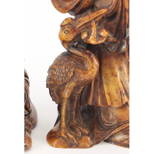 495 - Two Chinese russet soapstone carvings including one of an elder, character marks to the base, the la... 