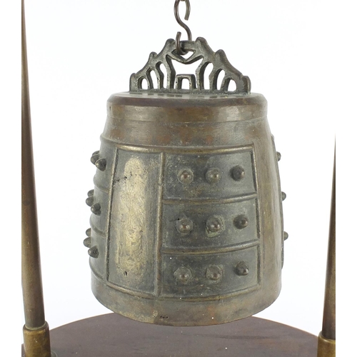 468 - Antique Sino-Tibetan bronze temple bell on later stand, overall 64cm high, the bell 22cm high