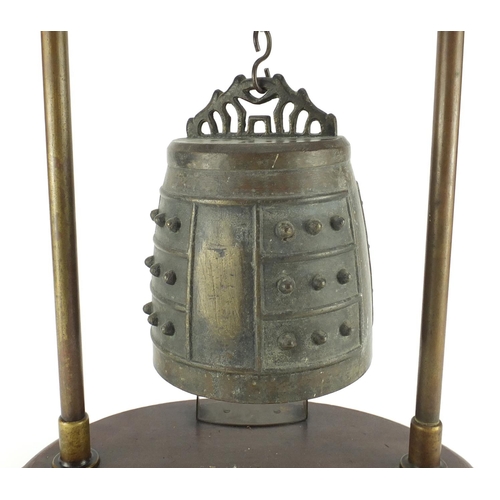 468 - Antique Sino-Tibetan bronze temple bell on later stand, overall 64cm high, the bell 22cm high