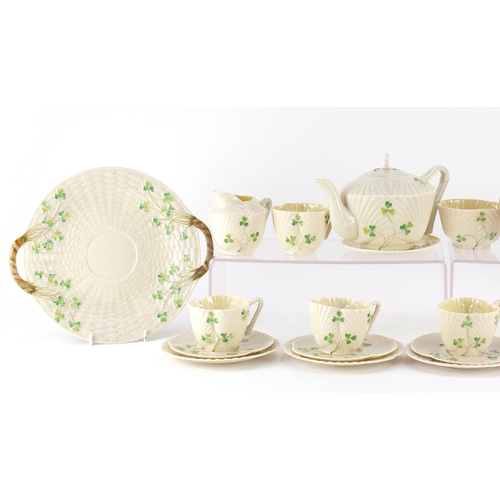 629 - Belleek porcelain including teapot, trio's, side plates and a cauldron, the teapot 12.5cm high
