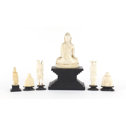 546 - Asian ivory carvings including three Buddha's and a fisherman all raised on ebonised stands, the lar... 