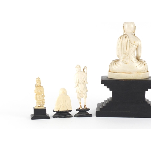 546 - Asian ivory carvings including three Buddha's and a fisherman all raised on ebonised stands, the lar... 