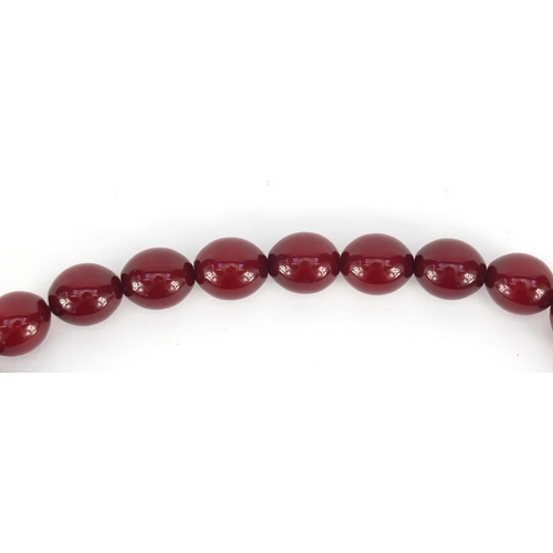 548 - Islamic cherry amber coloured bead prayer necklace, overall 48cm in length, the largest bead approxi... 
