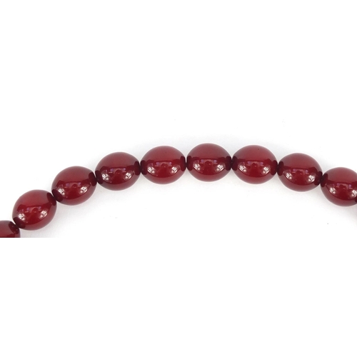 548 - Islamic cherry amber coloured bead prayer necklace, overall 48cm in length, the largest bead approxi... 