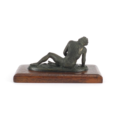 29 - Classical patinated bronze of the Dying Gaul, raised on a rectangular wooden base, 16.5cm wide