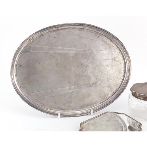 779 - Art Deco oval silver tray, hand mirror and powder pot, the tray hallmarks Birmingham 1930, 29cm wide... 