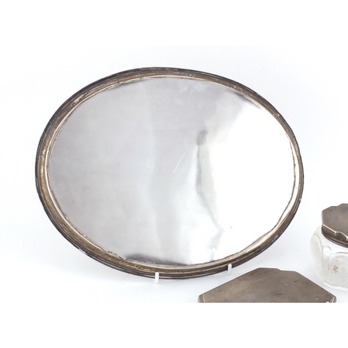 779 - Art Deco oval silver tray, hand mirror and powder pot, the tray hallmarks Birmingham 1930, 29cm wide... 