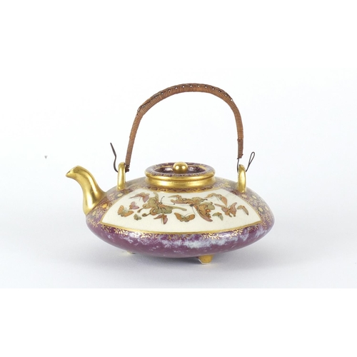 453 - Japanese Satsuma pottery squatted teapot with swing handle, hand painted and gilded with panels of b... 