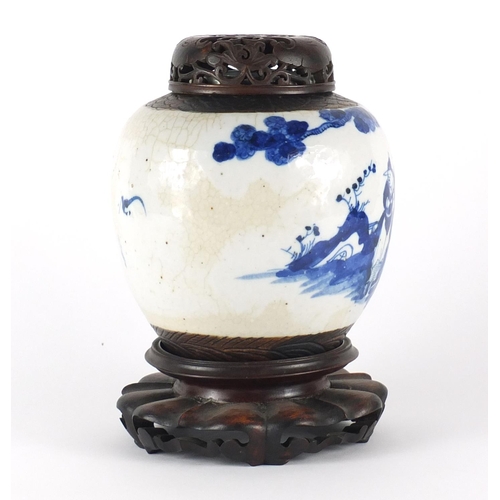 358 - Chinese blue and white ginger jar with carved hardwood lid on stand, the ginger jar hand painted wit... 