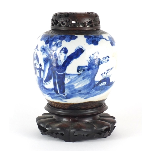 358 - Chinese blue and white ginger jar with carved hardwood lid on stand, the ginger jar hand painted wit... 