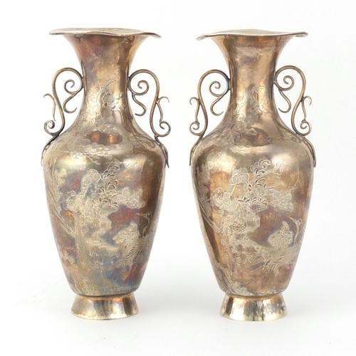 474 - Pair of Chinese silver vases with twin handles, each engraved with figures and cranes, character mar... 