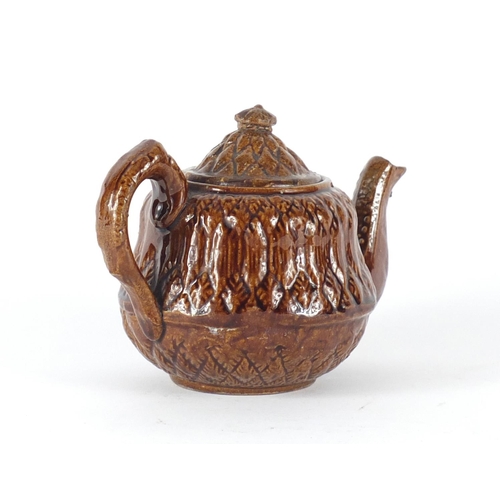 616 - 19th century treacle glazed pottery teapot with corn design , 11cm high