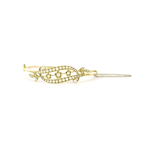 870 - Art Nouveau 15ct gold seed pearl floral bangle, 6.5cm wide, 9.6g