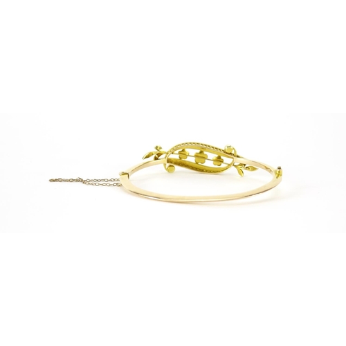 870 - Art Nouveau 15ct gold seed pearl floral bangle, 6.5cm wide, 9.6g