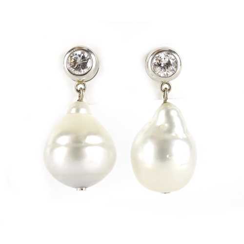 842 - Pair of unmarked white gold pearl and diamond solitaire drop earrings, 3.2cm in length, 16.6g