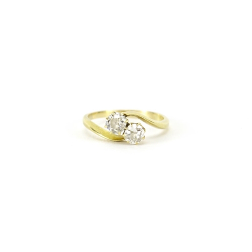 856 - Unmarked gold diamond two stone crossover ring, size L, 2.3g