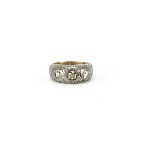 861 - Unmarked gold and silver ring set with a central champagne diamond and two clear diamonds, size N, 6... 