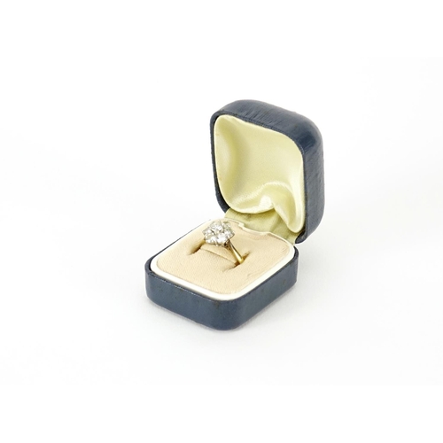 839 - 18ct gold diamond seven stone flower head ring, size M, 3.8g
