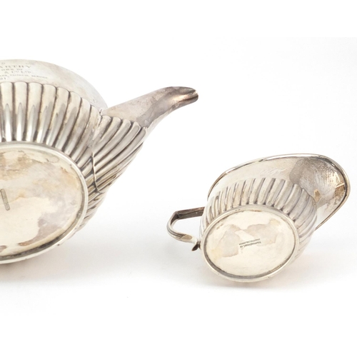 760 - Silver demi fluted three piece tea service by Mappin & Web, Sheffield 1919, the teapot 25cm wide, 67... 
