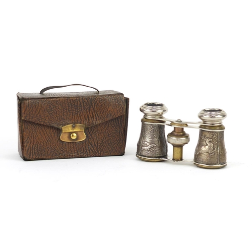 91 - Pair of opera glasses, the barrels decorated with stags and hounds, housed in a velvet lined travel ... 