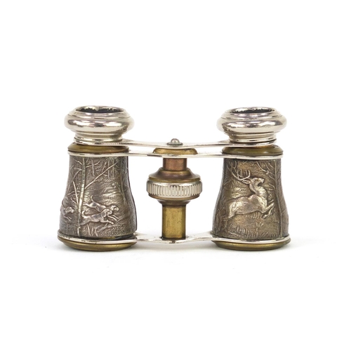 91 - Pair of opera glasses, the barrels decorated with stags and hounds, housed in a velvet lined travel ... 