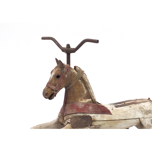 177 - Antique French carved wooden cast iron ride on pedal horse, 72cm in length
