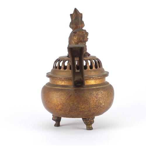 467 - Chinese gilt metal tripod incense burner with twin handles and pierced dog-of-foo design lid, 34cm h... 