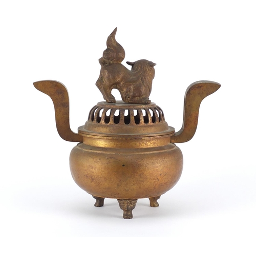 467 - Chinese gilt metal tripod incense burner with twin handles and pierced dog-of-foo design lid, 34cm h... 