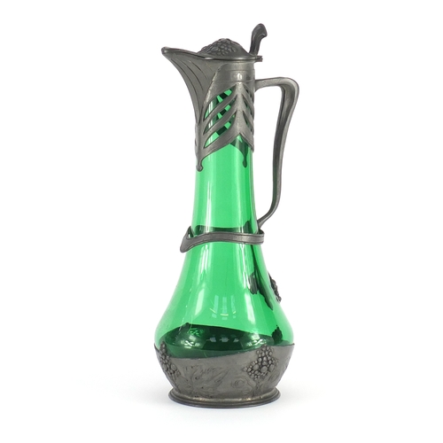 723 - Art Nouveau pewter and green glass claret jug by Osiris, embossed with grapes on vines, impressed Os... 