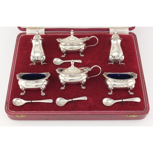 751 - Silver six piece cruet with blue glass liners, hallmarked Birmingham 1968, housed in a velvet and si... 