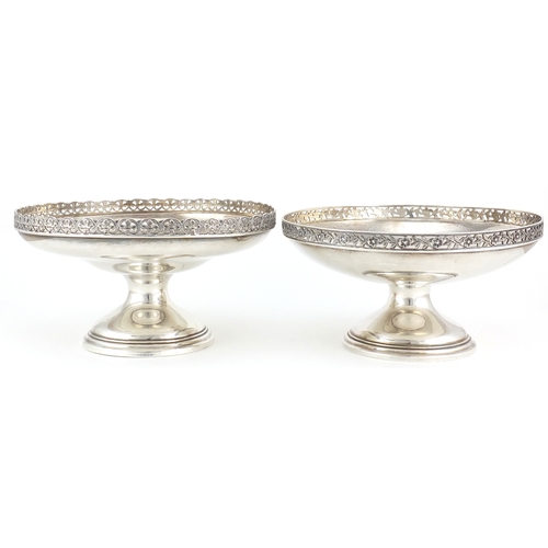 774 - Two circular silver pedestal dishes with pierced floral borders, one by Mappin & Webb London 1922 an... 