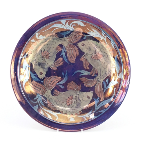689 - Johnathon Chiswell Jones lustre charger hand painted with three stylised fish, painted marks and num... 