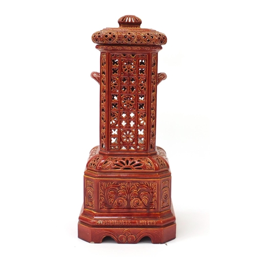 684 - Burmantofts faience veritas oil stove and cover, cast with stylised Moorish foliate panels having an... 