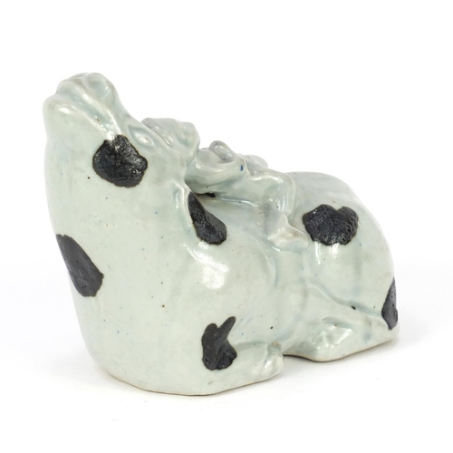 419A - Chinese celadon glazed model of a figure on cow, 20cm in length