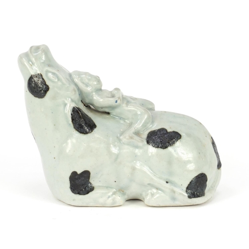 419A - Chinese celadon glazed model of a figure on cow, 20cm in length