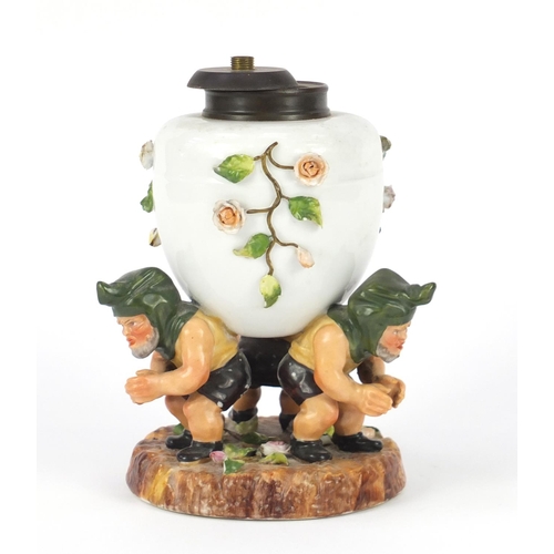631 - Continental hand painted porcelain gnome design lamp base, indistinct factory marks to the base, num... 