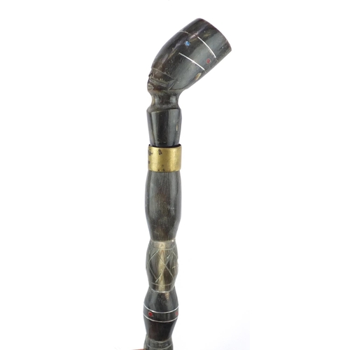81 - Segmented horn walking stick with figural pommel, 94cm in length